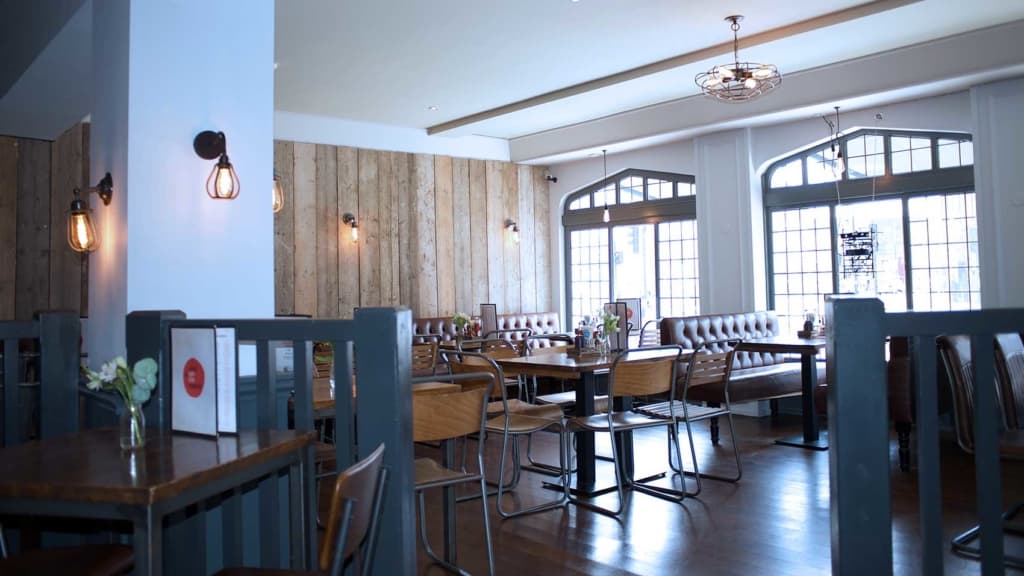 Finished restaurant dining room with fitted tables, seating and wall panelling